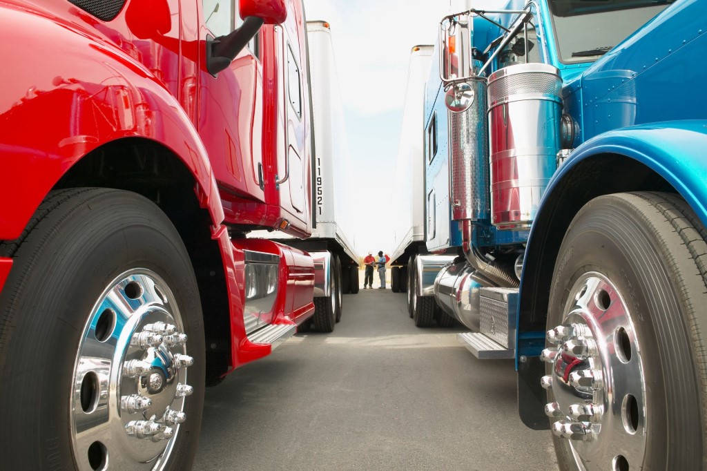 Find Your Path | Truck Drivers Standing Between Trucks - Truck Drivers Talking While Standing Between Red and Blue Trucks